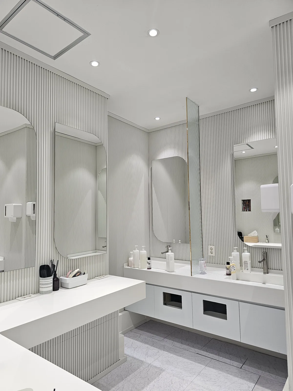 Powder room with mirrors and amenities for patients